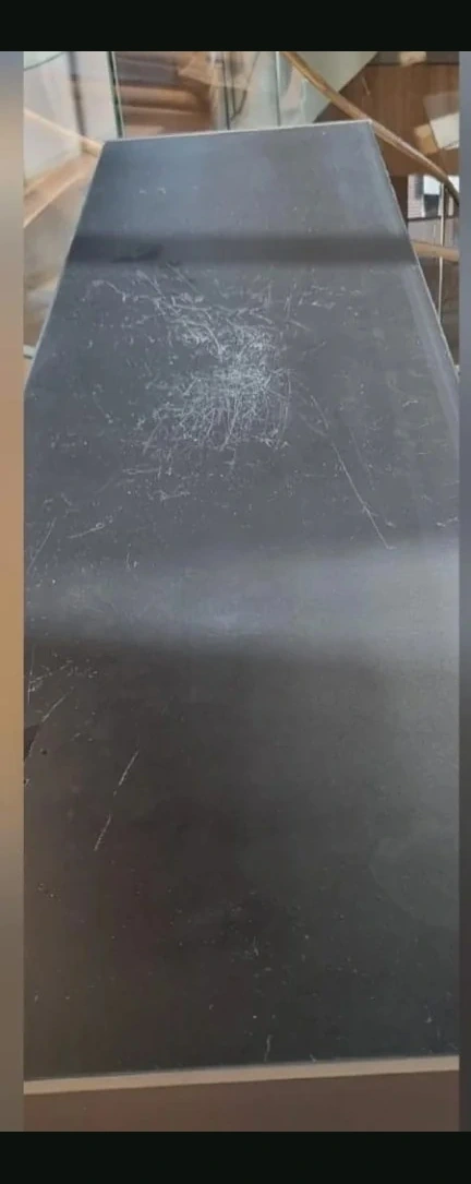 Scratched dark table before high-gloss refinishing